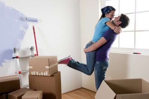 Organised moving day scene with labeled boxes and removalists in Monument